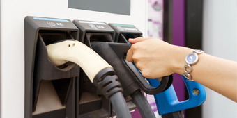 A close up of an electric car being charged